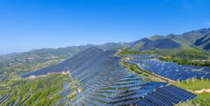 Green hillsides covered with thousands of solar panels.